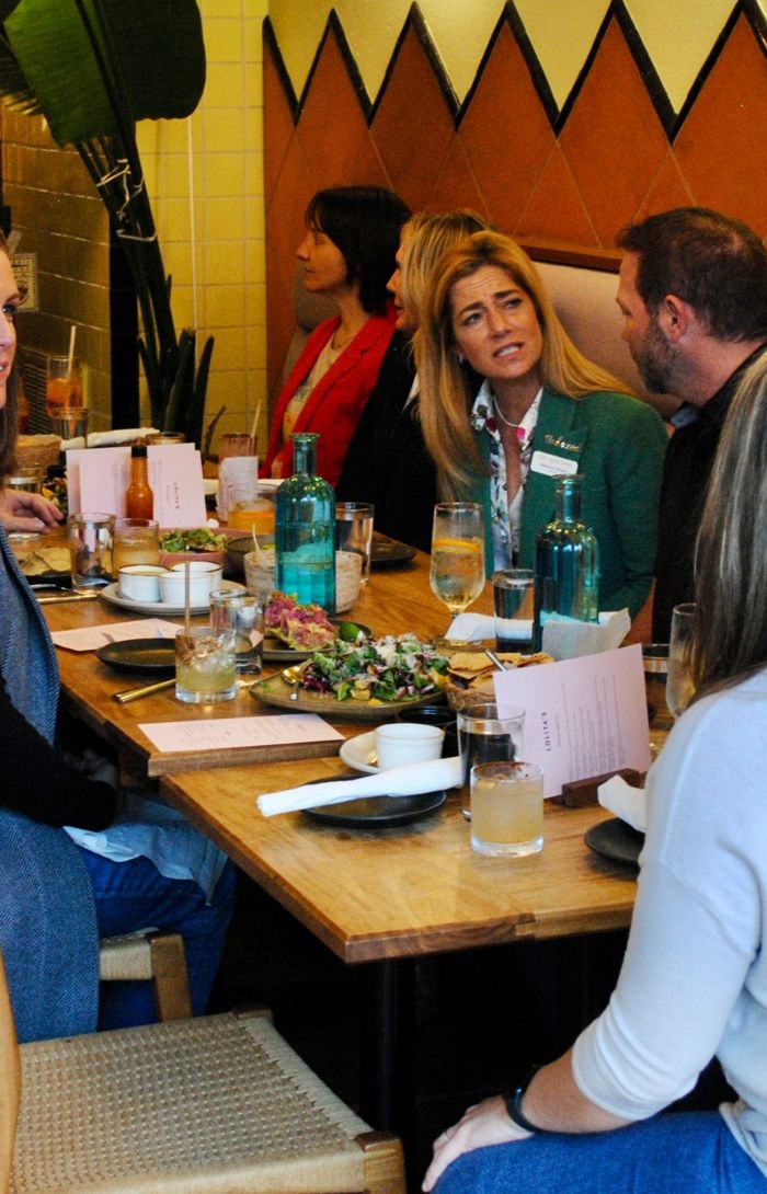 Guests talking over dinner at a long table at Lolita's