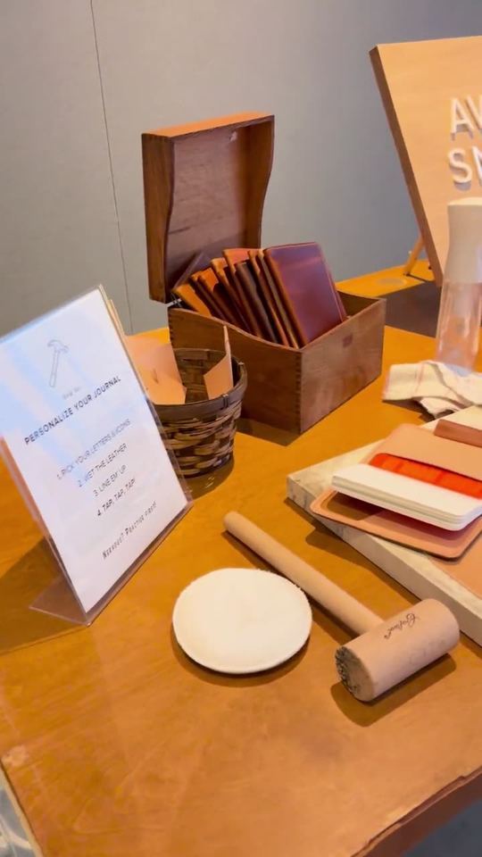 Awl Snap's leather stamping station set up with tools and notebook covers